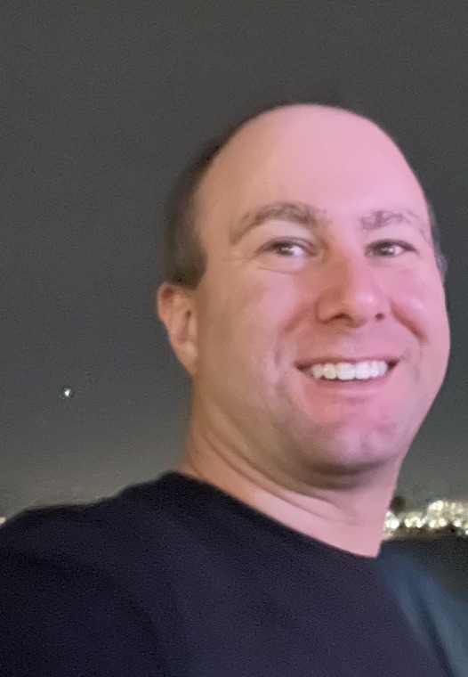 Chris Babayans in front of a skyline